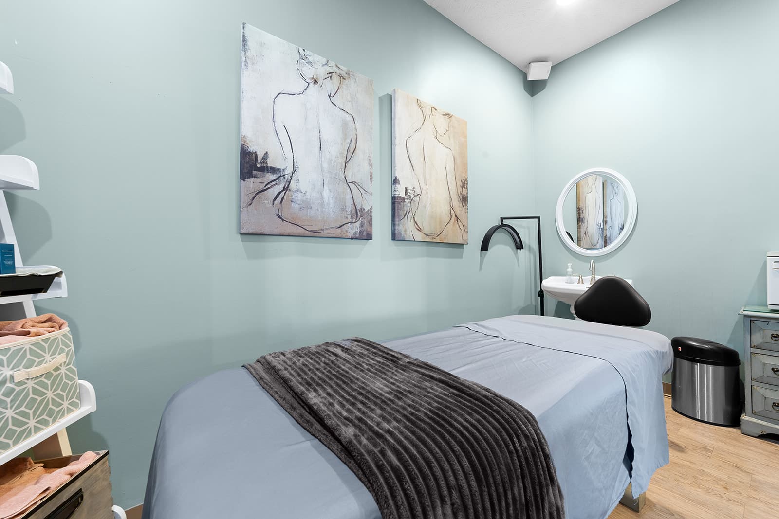 Love's Hair & Spa treatment room with artwork and massage bed